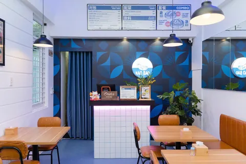 Bao Bao's dining room: wooden tables, an Order here counter and three menu boards above it